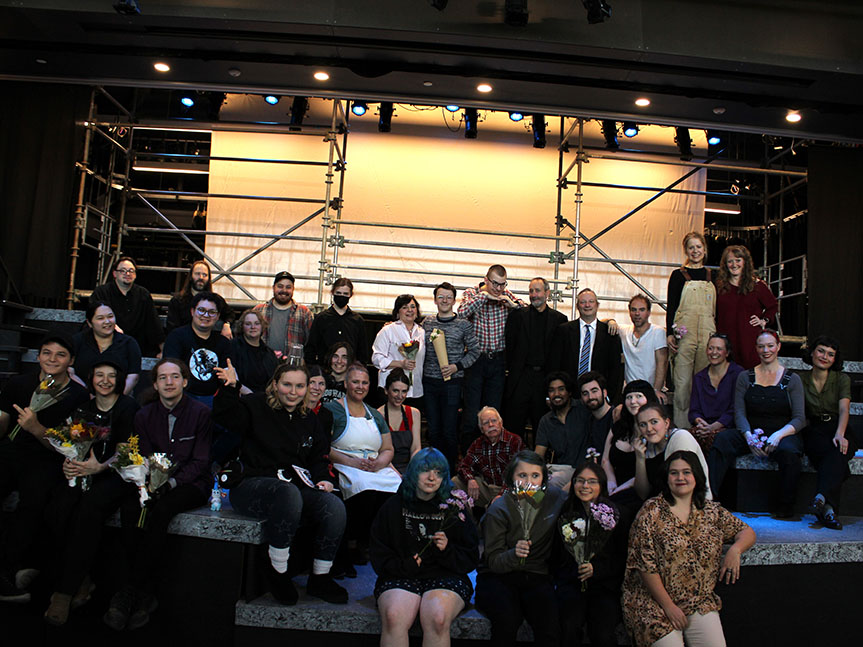 Cast and crew group photo taken on stage