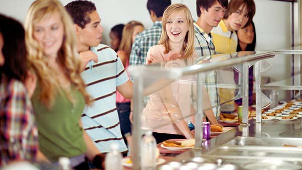 kids in the cafeteria smiling